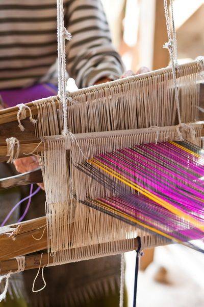 Master weaver hand-knotting a carpet on the loom
