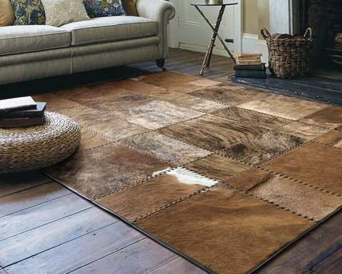Dark brown cowhide leather rug with gold Greek border