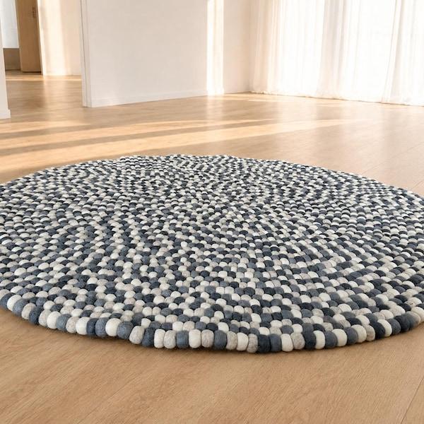 Blue grey felt pebble round rug on wooden floor