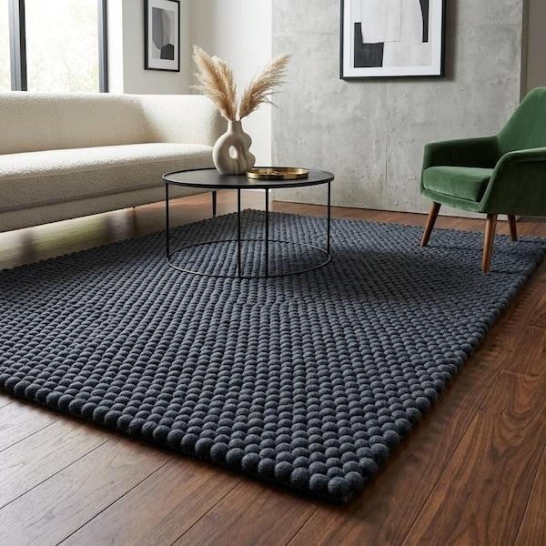 Dark charcoal felt pebble rectangular rug in living room