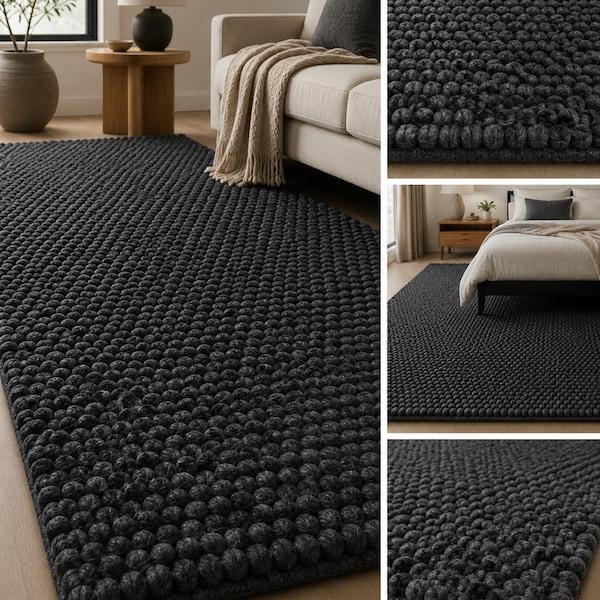 Dark charcoal felt pebble rug texture and bedroom setting