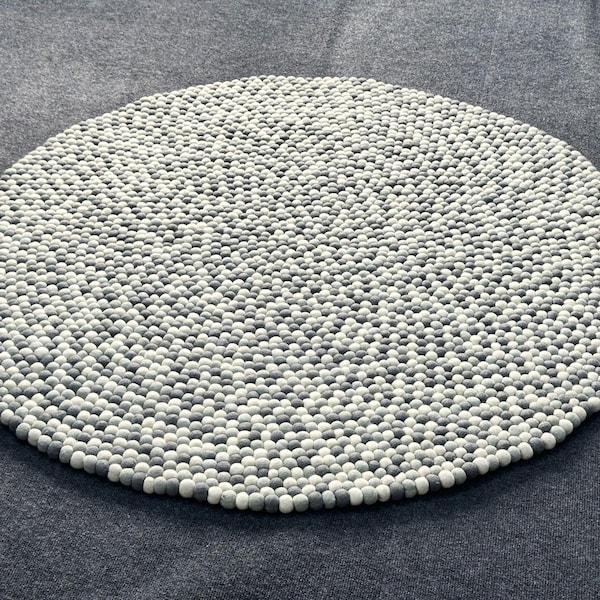Grey and white felt pebble round rug close-up