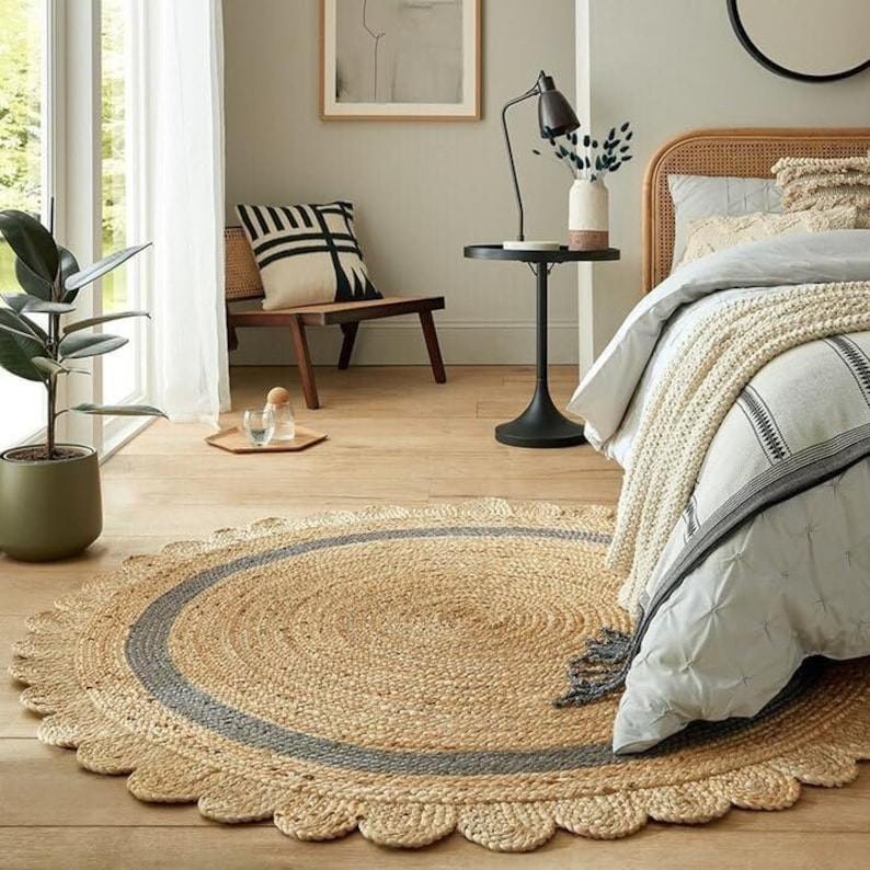 Round natural jute rug with grey border scallop edge in bedroom