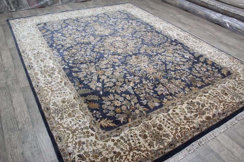 Navy floral hand knotted silk carpet displayed flat close up
