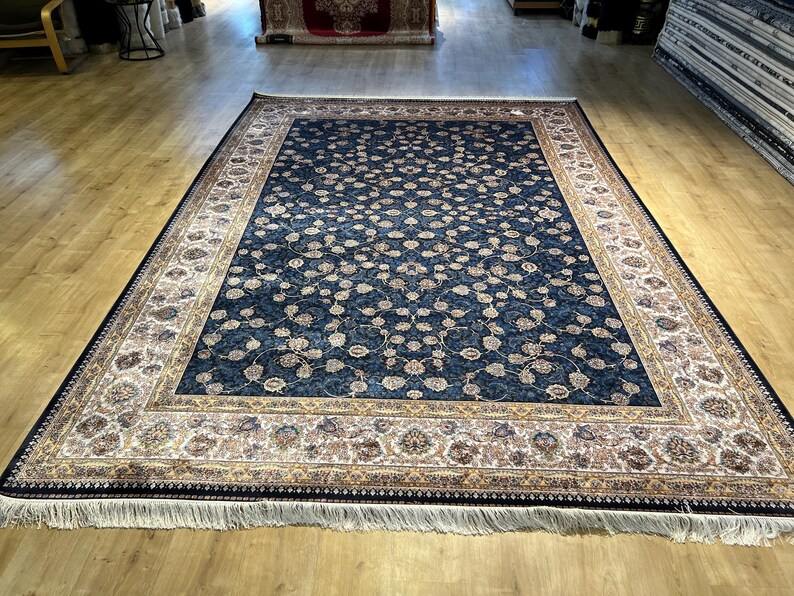 Navy floral hand knotted silk rug in showroom display
