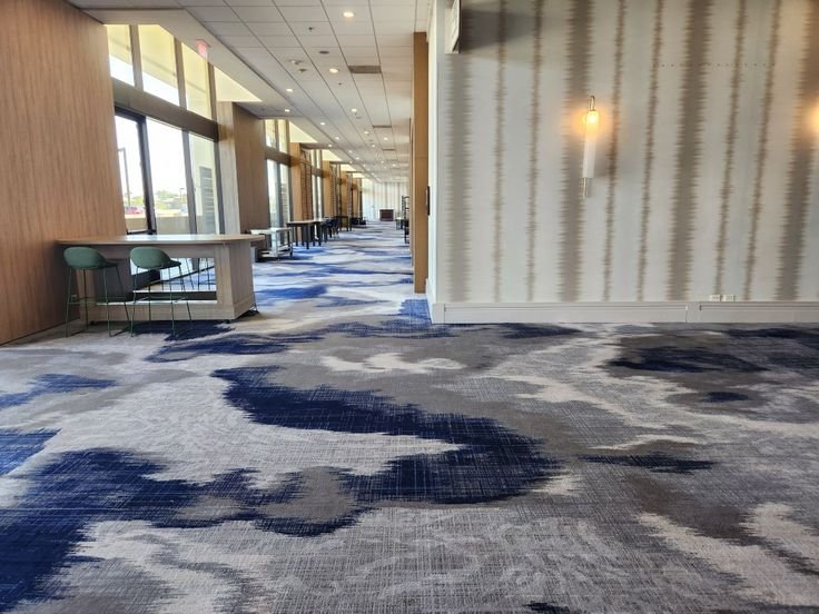 Navy blue and grey ikat cloud pattern wall to wall carpet in lounge area