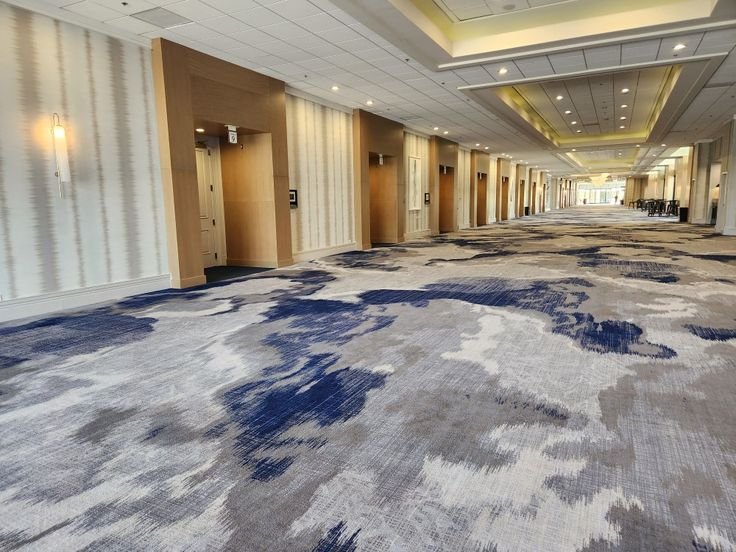Navy blue and grey abstract cloud pattern wall to wall carpet near elevator lobby