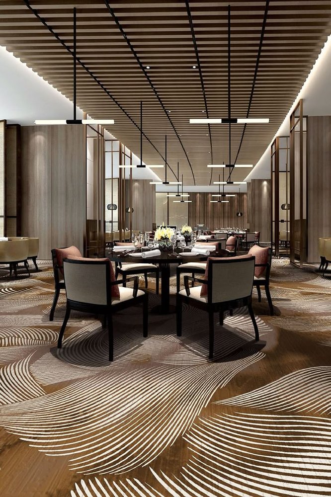 Bronze and cream feather swirl pattern wall to wall carpet in fine dining restaurant
